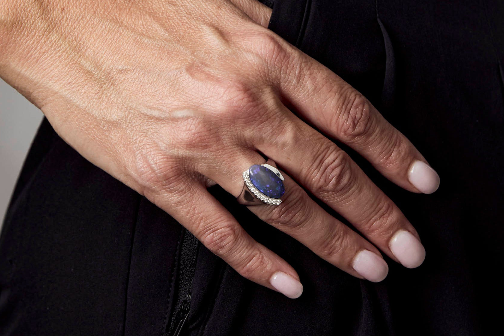 Ring with a large purple opal and diamond-studded band on a white background | Ikecho Australia