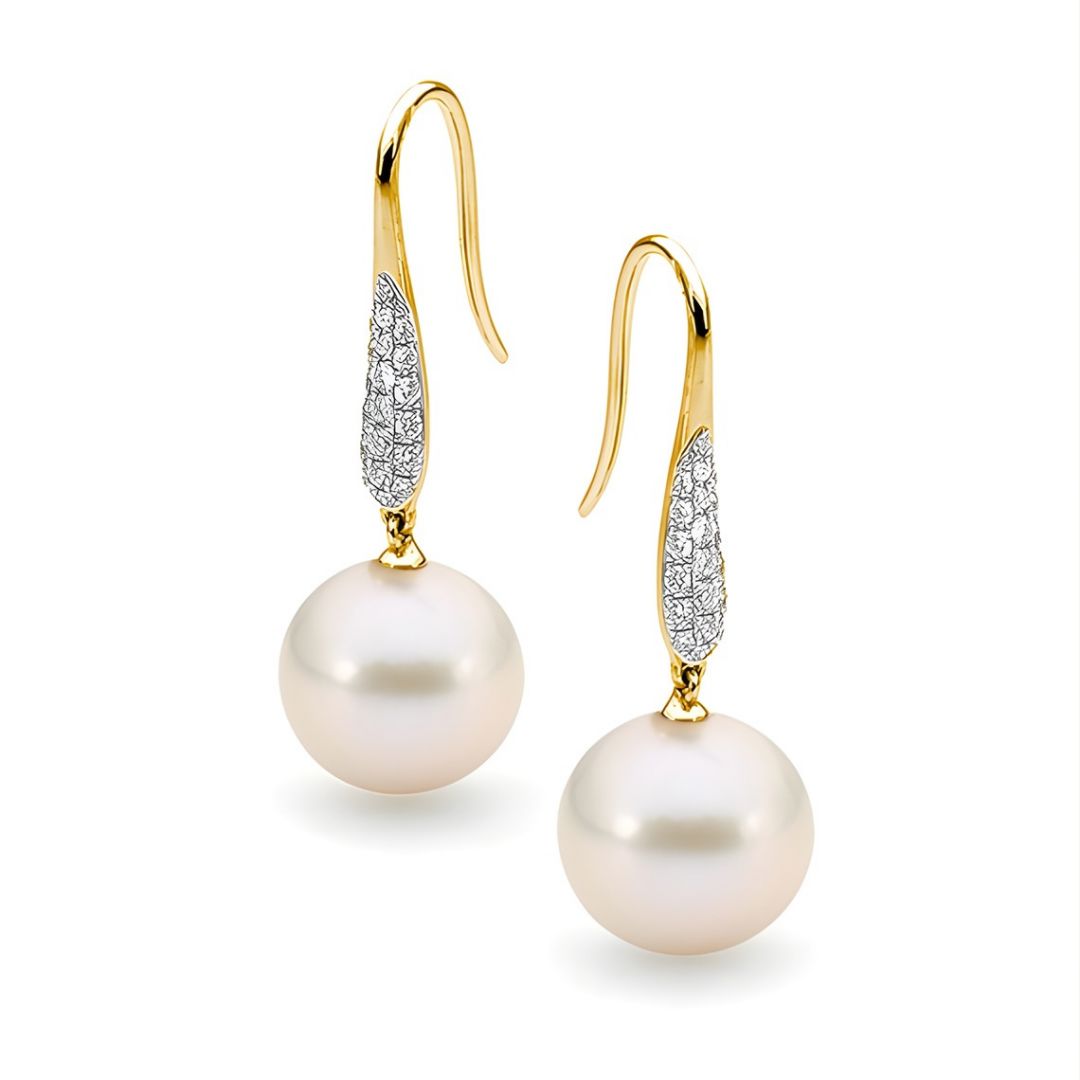 Pearl earrings with gold hooks and diamond accents on a white background | Ikecho Australia