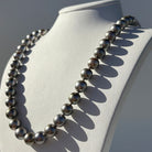 Strand necklace made of black pearls on a mannequin bust against a neutral background | Ikecho Australia
