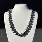 Necklace made of dark Tahitian pearls on a white mannequin bust | Ikecho Australia