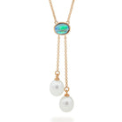 A lariat-style necklace with a solid light opal centerpiece and two drop-shaped cultured freshwater pearls, crafted in 9ct yellow gold.